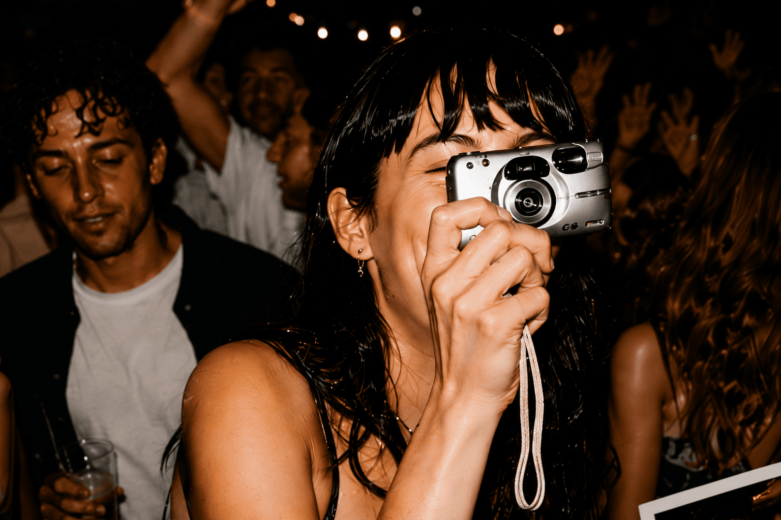 Guest taking a photograph with a silver compact digital camera
